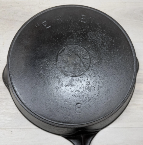 Antique Griswold cast iron "ERIE" "Spider" skille t pannumber 8 with heat ring sold for $4,000. Note the pitting and wear to the spider logo. 